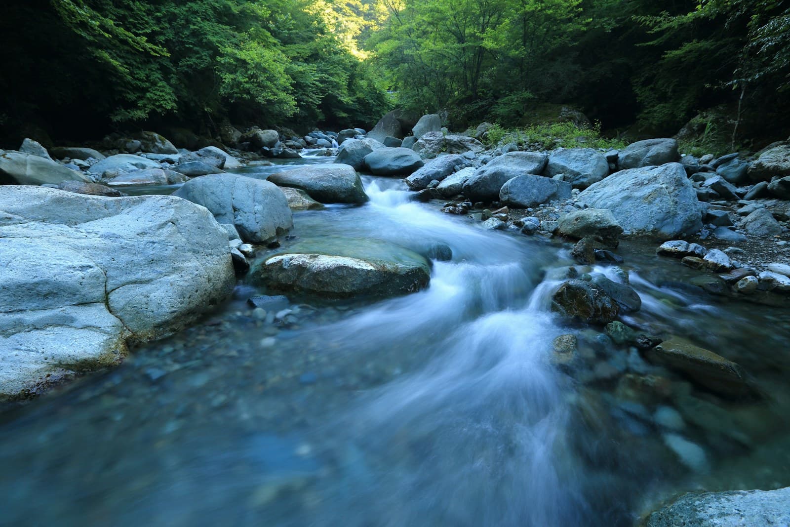 Surface of flowing water reflecting soft daylight